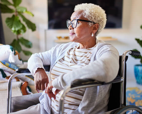 Estate planning for this senior woman in a wheelchair looking out the window