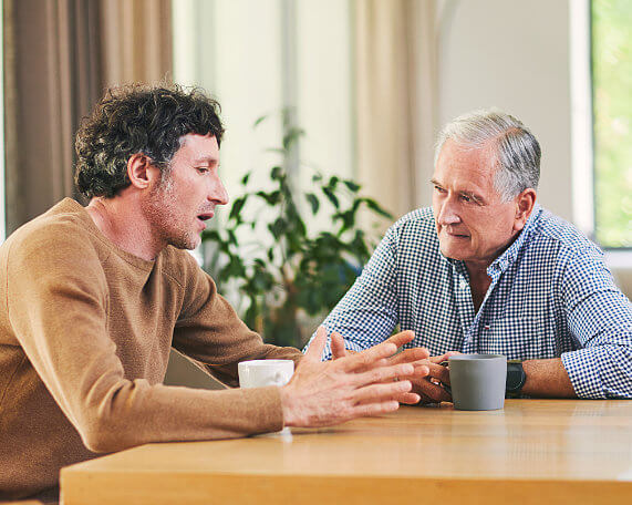 square photos Father and son at a table discussing probate litigation for a loved ones estate
