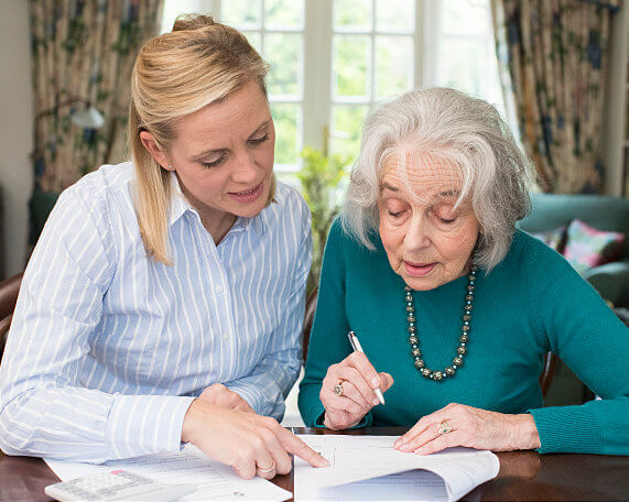 square photos A senior coupling discussing wills and trusts with an elder law attorey
