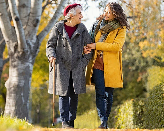 Mother and adult daughter walking down the sidewalk